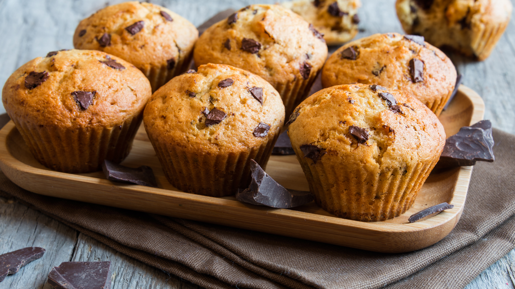 Chocolate Chip Banana Muffins recipe blog post. Tray of delicious chocolate chip banana muffins.